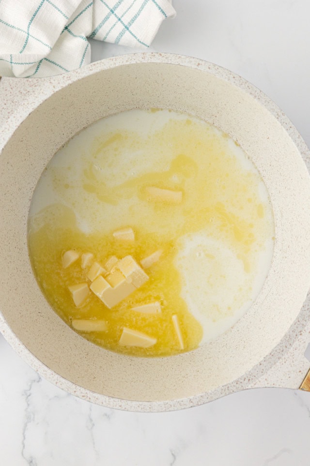 overhead view of water, milk, butter, sugar, and salt in a saucepan