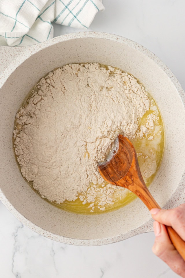 overhead view of flour added to choux pastry mixture