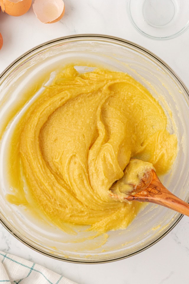 overhead view of mixed choux pastry dough in a glass mixing bowl