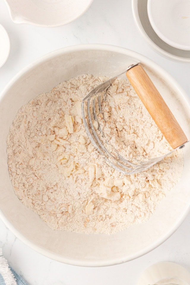overhead view of butter cut into dry ingredients for scones