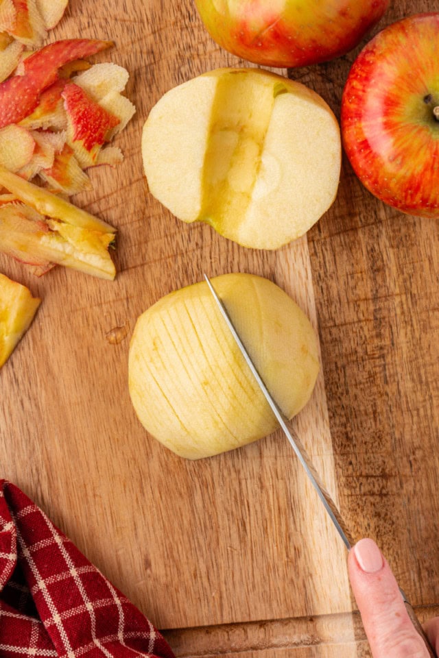 overhead view of an apple being sliced for German apple cake