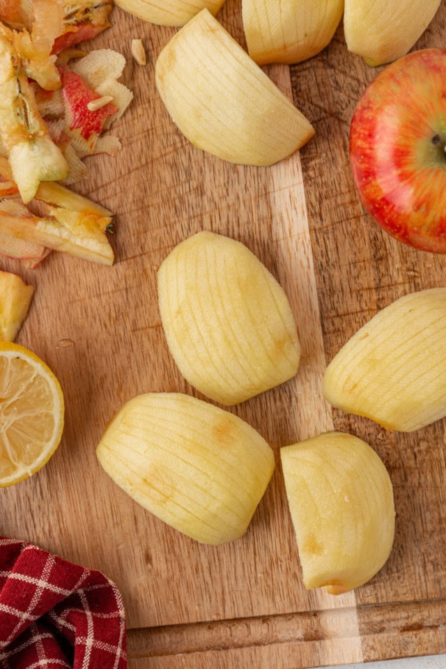 overhead view of partially sliced apples for topping German apple cake