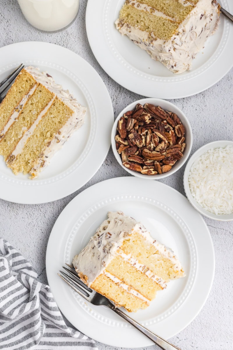 overhead view of three slices of Italian cream cake on white plates
