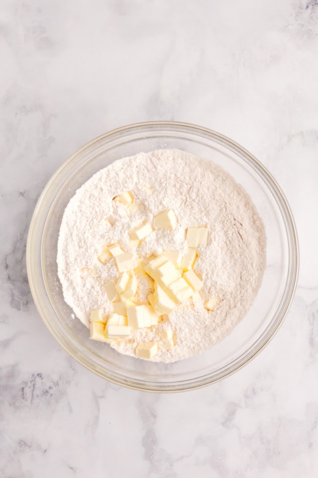 overhead view of butter added to dry ingredients for biscuits