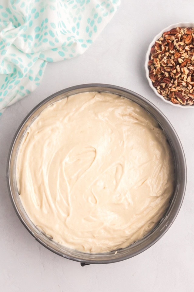 overhead view of pecan pie coffee cake batter in a springform pan ready to go into the oven