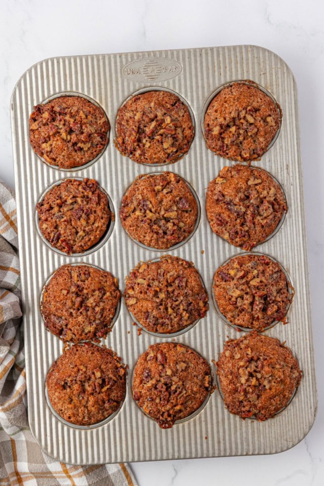 overhead view of freshly baked pecan praline muffins in a muffin pan