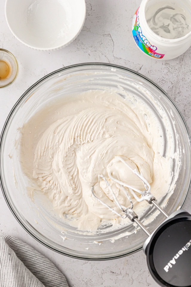 overhead view of marshmallow buttercream in a glass mixing bowl