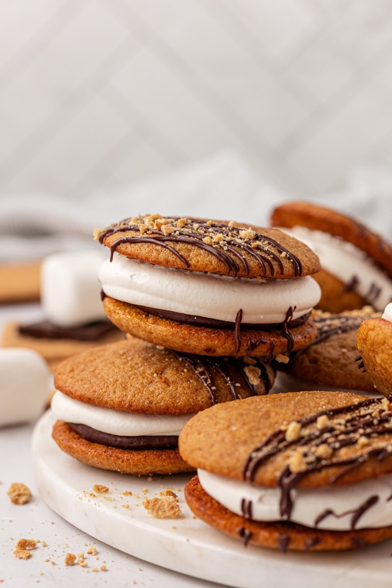 s'mores whoopie pies stacked on a white plate
