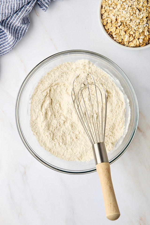 overhead view of flour, baking soda, and salt mixed in a glass mixing bowl