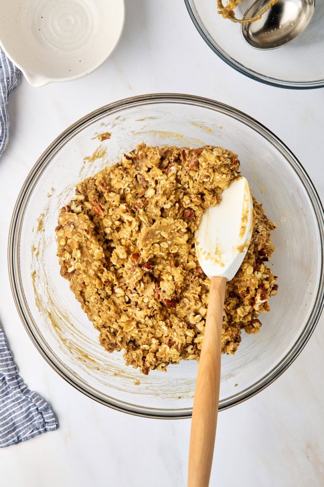 overhead view of brown butter maple oatmeal cookie dough in a glass mixing bowl