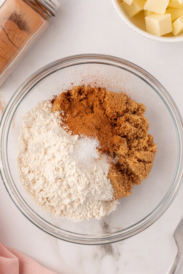 overhead view of brown sugar, flour, cinnamon, and salt i a mixing bowl
