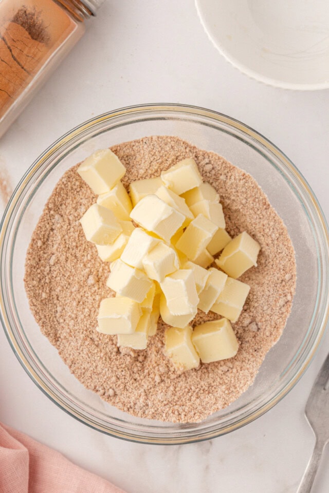 overhead view of butter added to crumb topping mixture
