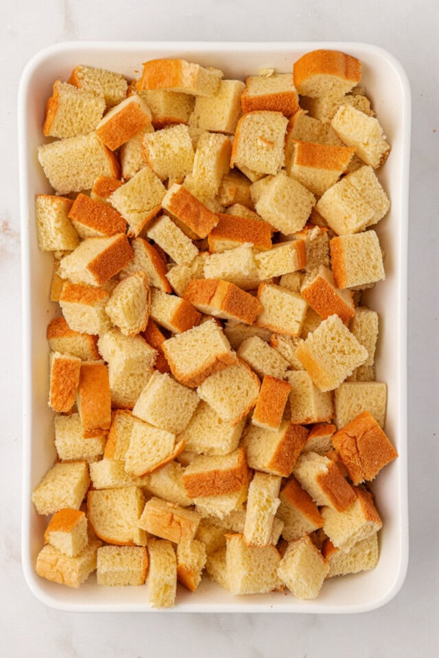 overhead view of cubed bread in a 9x13 pan