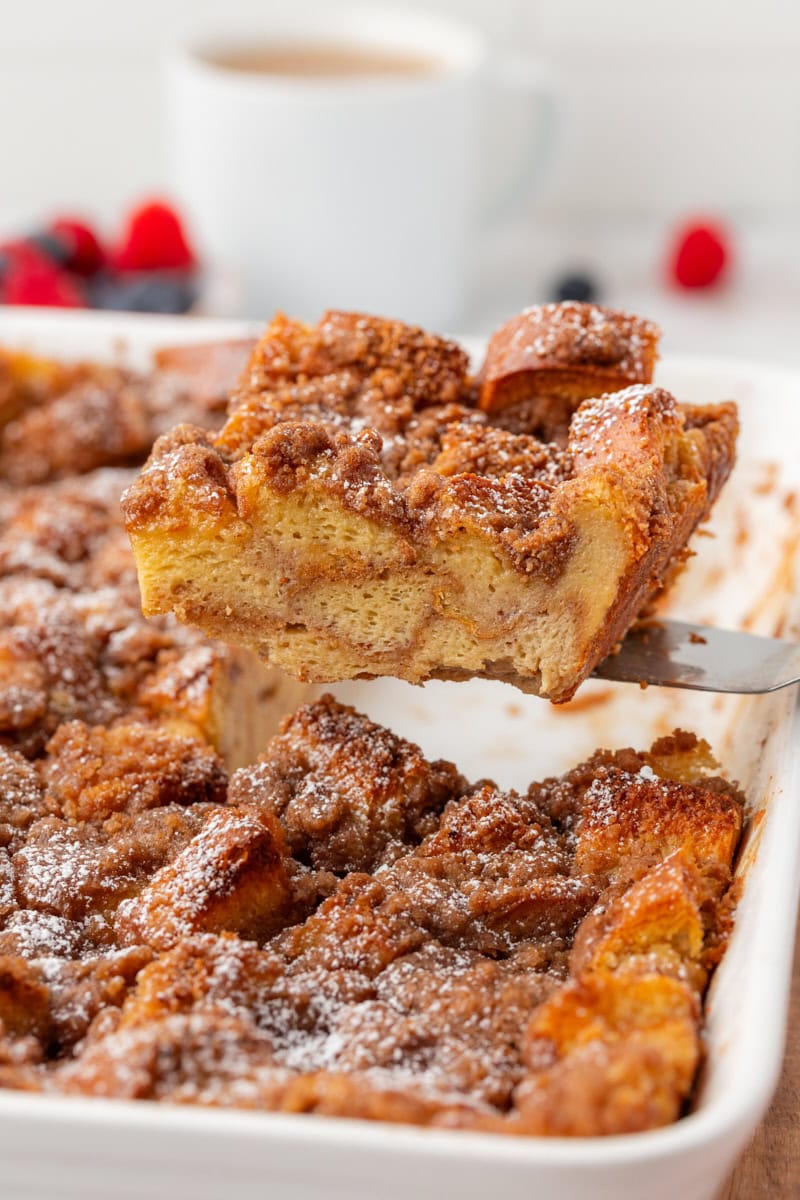 overhead view of a slice of baked French toast being lifted out of the pan