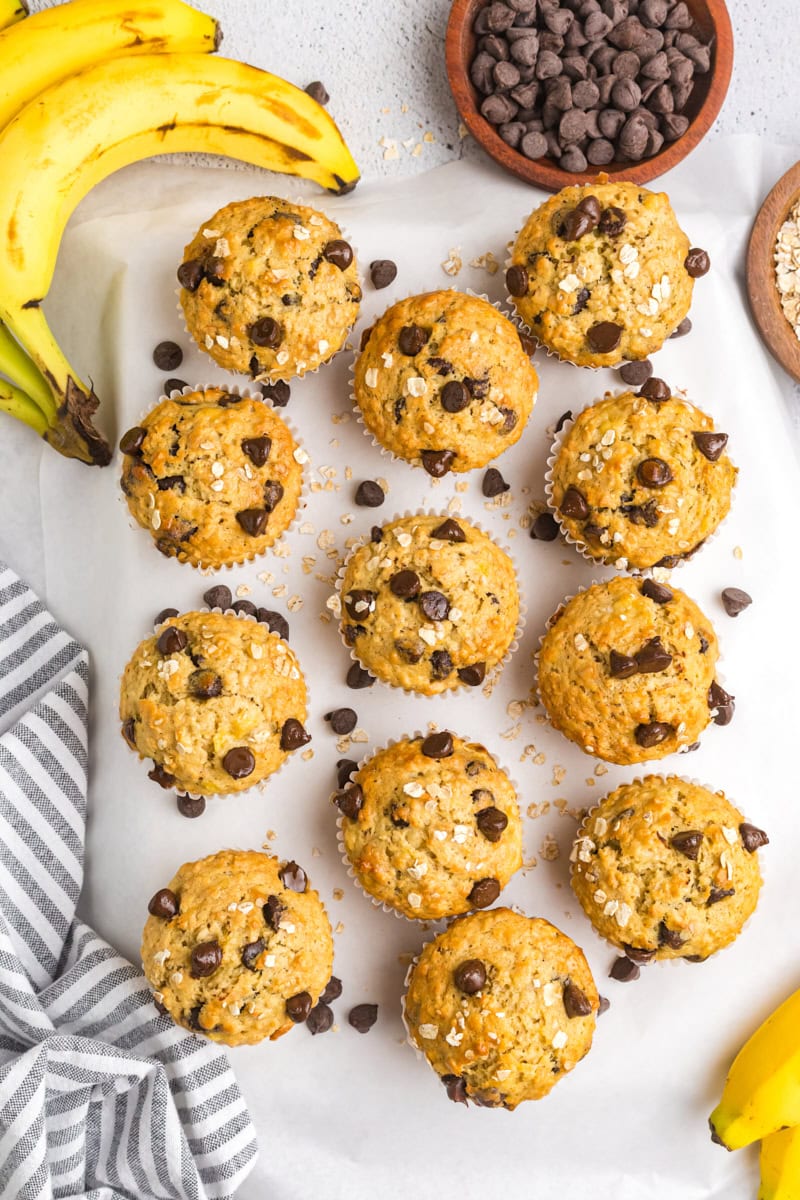 overhead view of banana oatmeal chocolate chip muffins on a white surface
