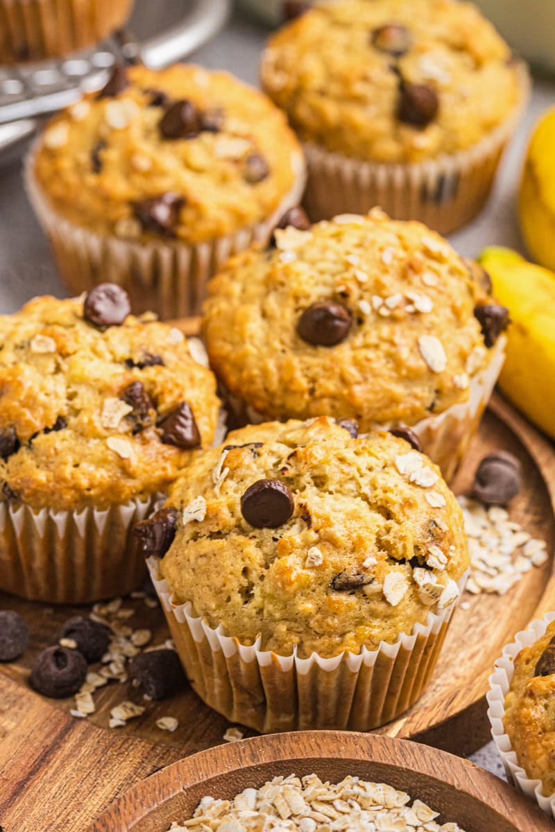 banana oatmeal chocolate chip muffins on a wooden serving board