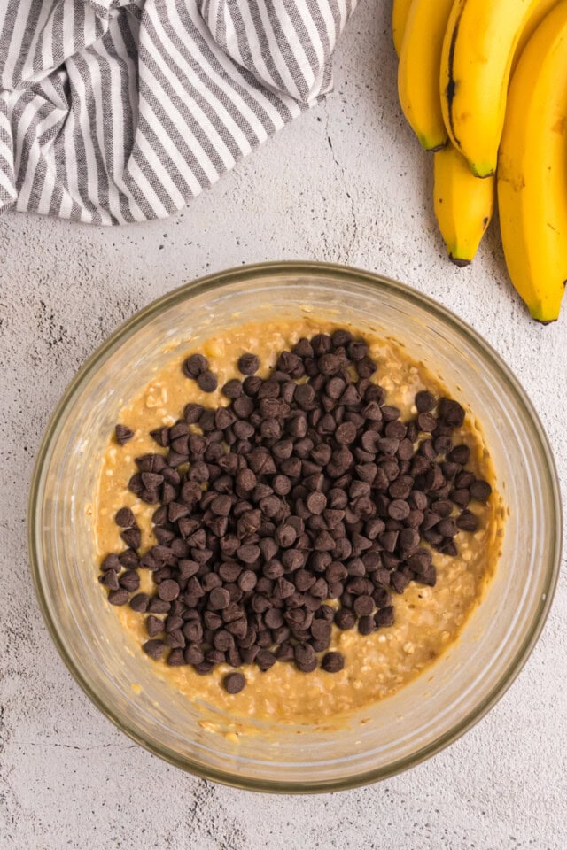 overhead view of chocolate chips added to banana muffin batter