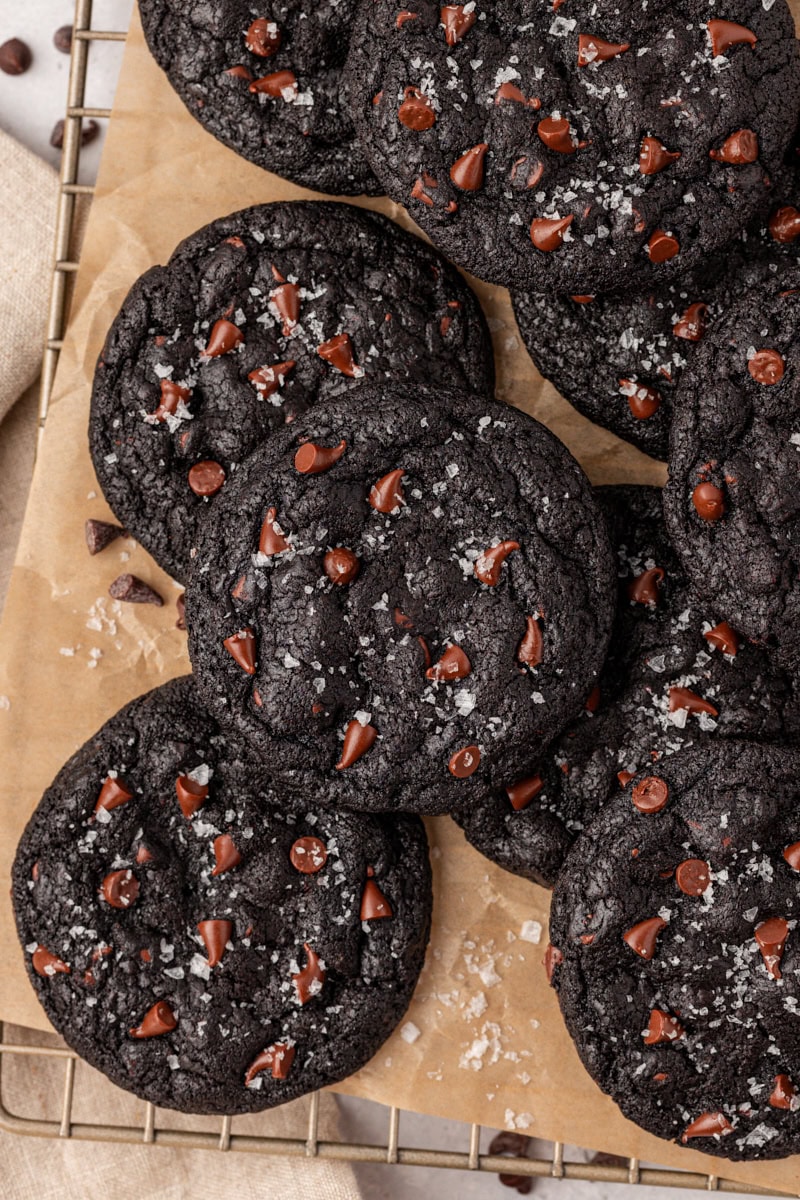 overhead view of black cocoa cookies on a sheet of parchment paper