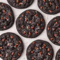 overhead view of black cocoa cookies on a white surface