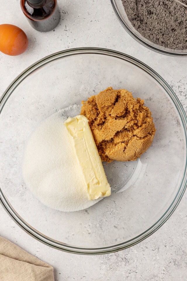 overhead view of butter, sugar, and brown sugar in a glass mixing bowl