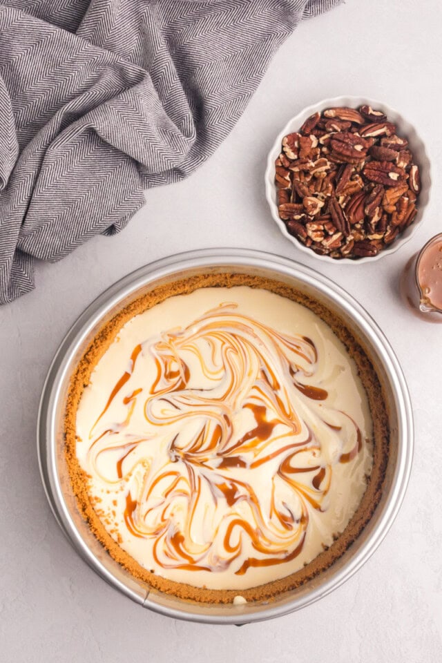 overhead view of caramel swirled into bourbon cheesecake batter