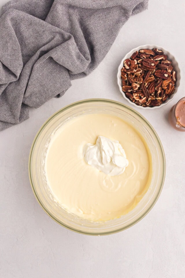 overhead view of sour cream added to cheesecake batter