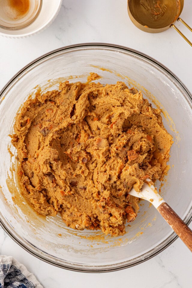 overhead view of Butterfinger cookie dough in a glass mixing bowl
