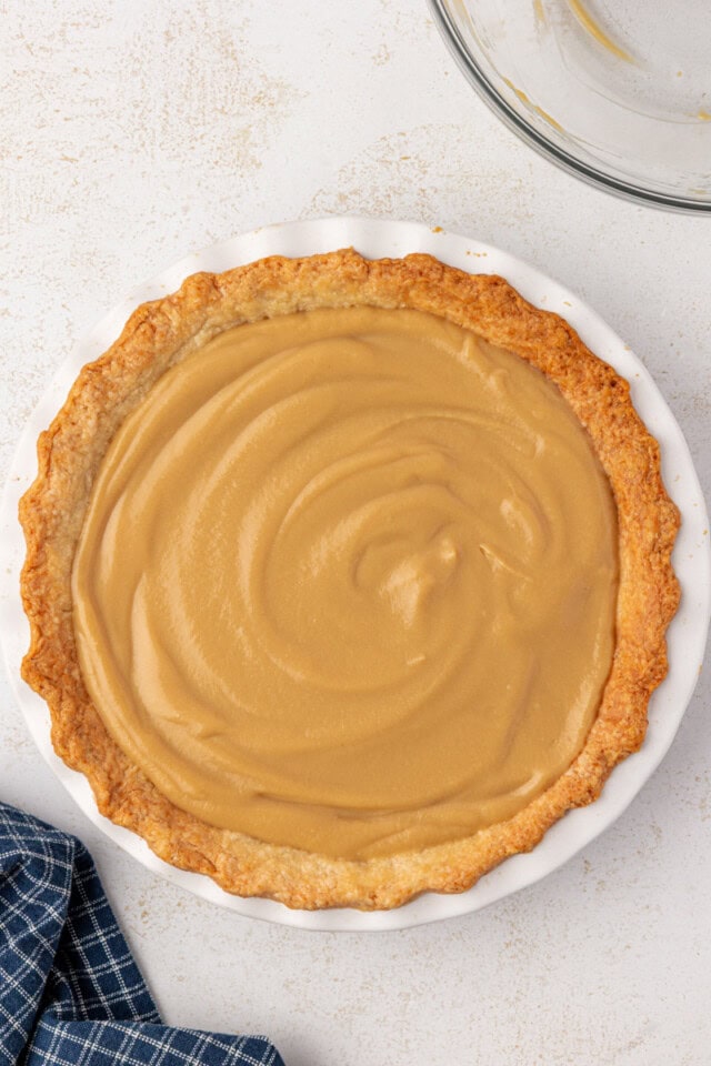 overhead view of butterscotch pie in a white pie plate