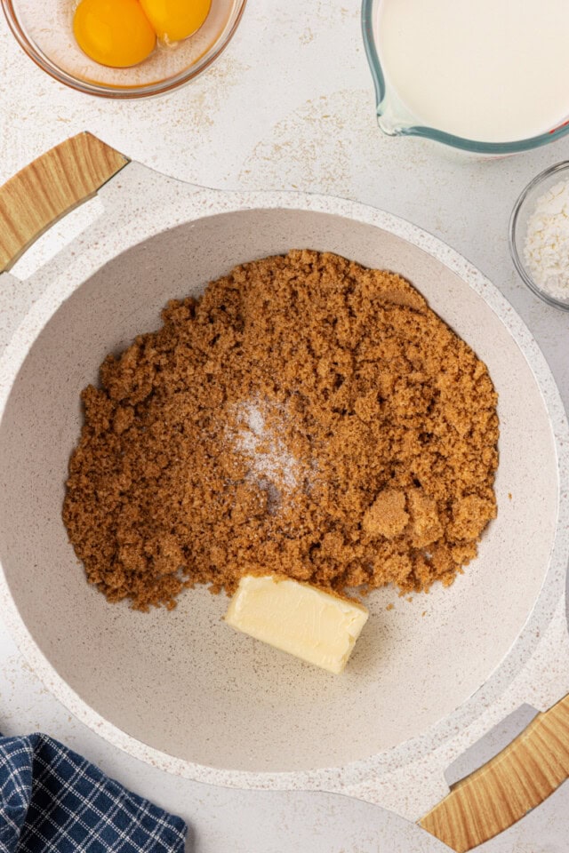 overhead view of butter and brown sugar in a white saucepan