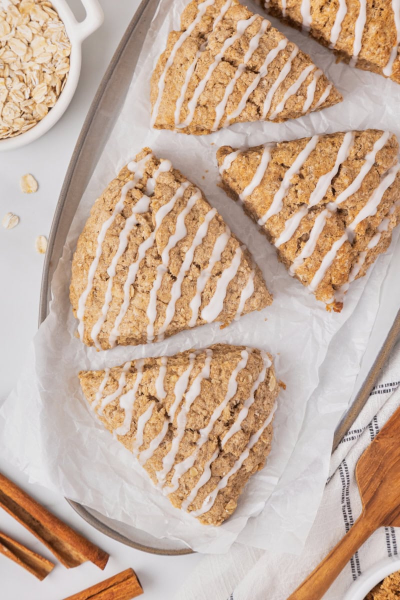overhead view of cinnamon oat scones on a white serving plate