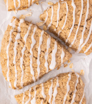 overhead view of three cinnamon oat scones on a white surface
