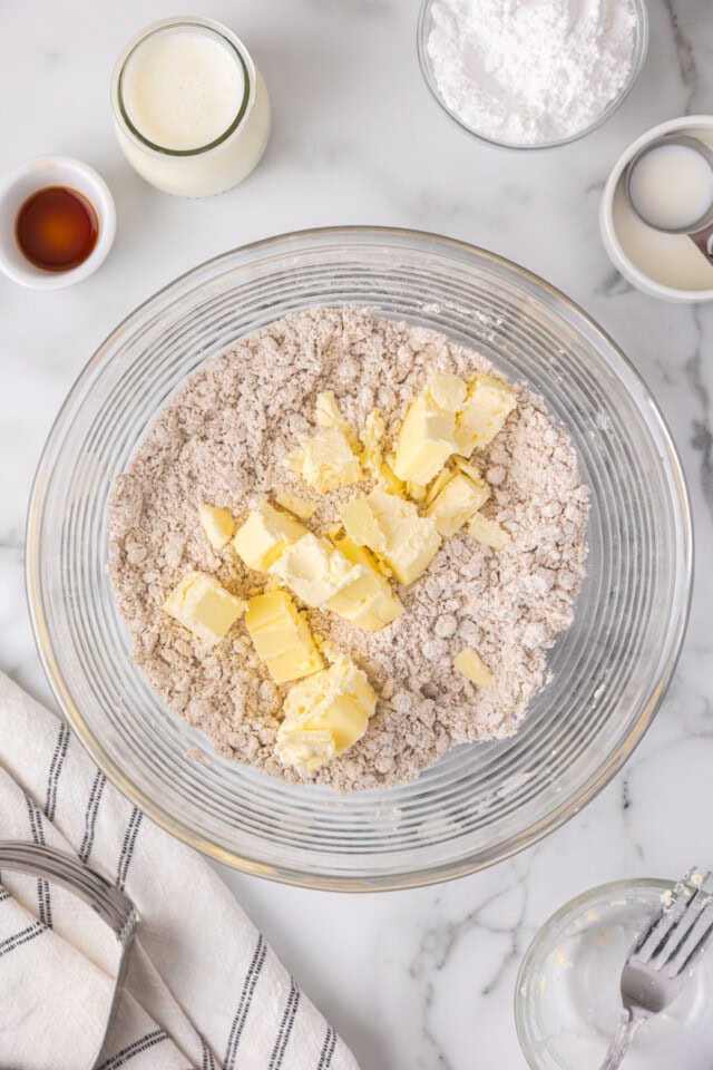 overhead view of butter cubes added to dry ingredients for scones