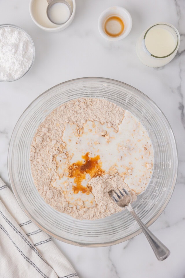overhead view of buttermilk and vanilla extract added to scone dough
