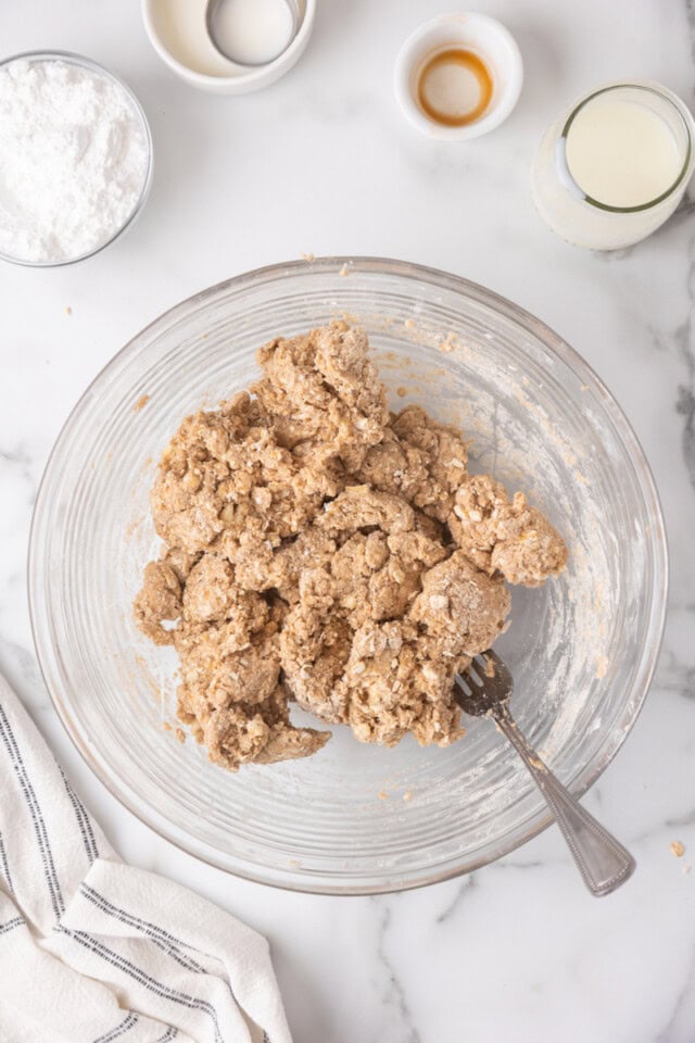 overhead view of cinnamon oat scone dough in a glass mixing bowl