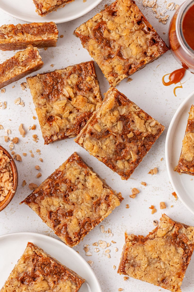 overhead view of several dulce de leche bars scattered on a white surface