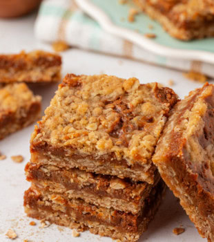 stack of three dulce de leche bars with more bars surrounding