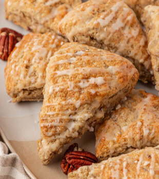 maple scones in a stacked pile on a serving plate