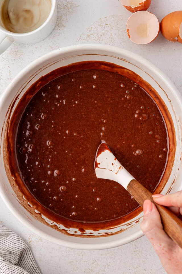 overhead view of chocolate cake batter in a white mixing bowl