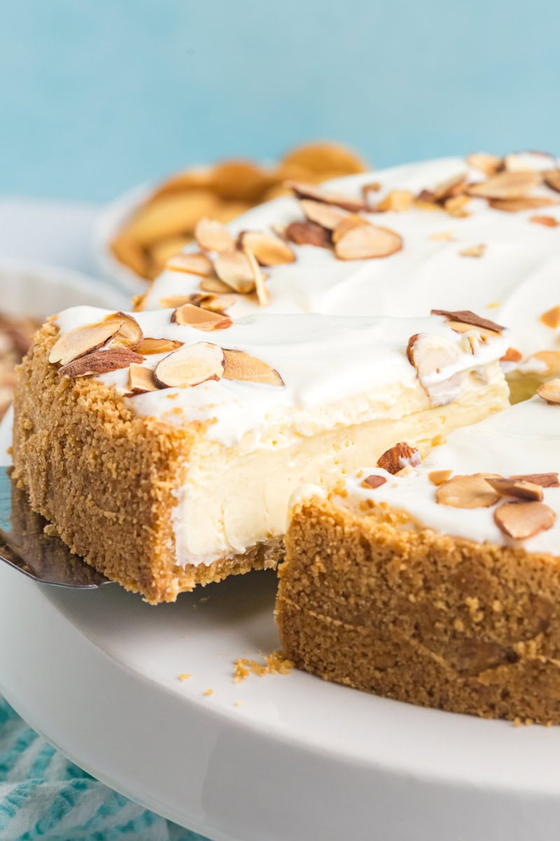 a slice of amaretto cheesecake being pulled away from the remaining cheesecake