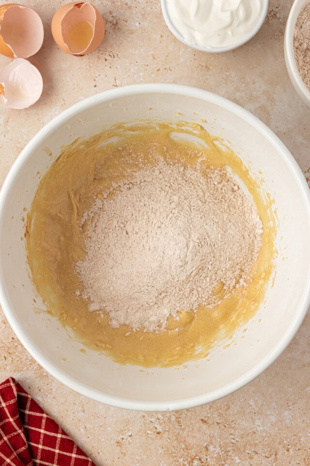 overhead view of dry ingredients added to apple cupcake batter