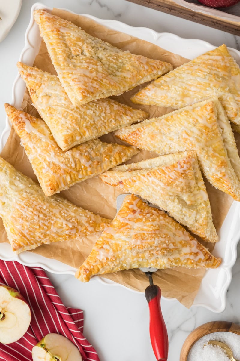 overhead view of apple turnovers served on a square white plate
