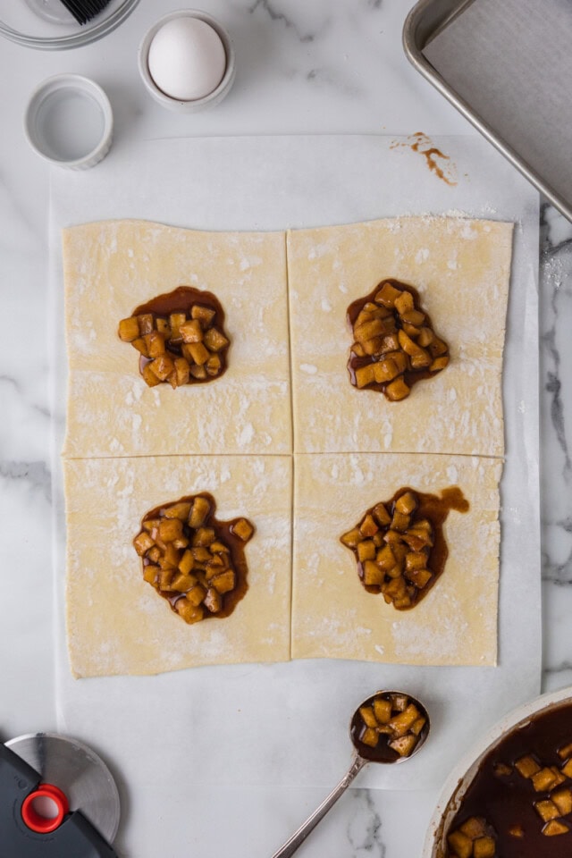 overhead view of apple filling scooped onto puff pastry squares