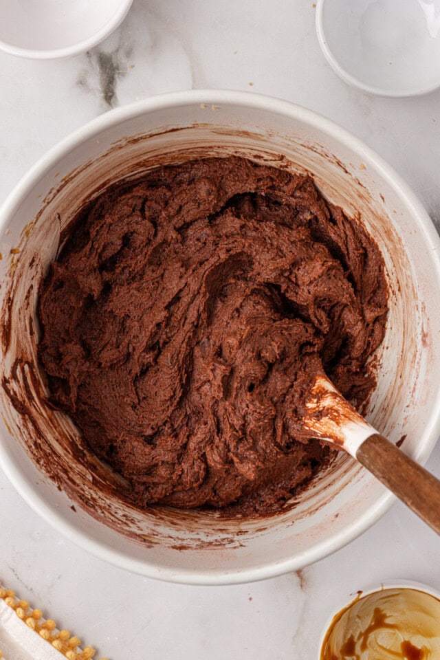 overhead view of chocolate ginger cookie dough in a white mixing bowl