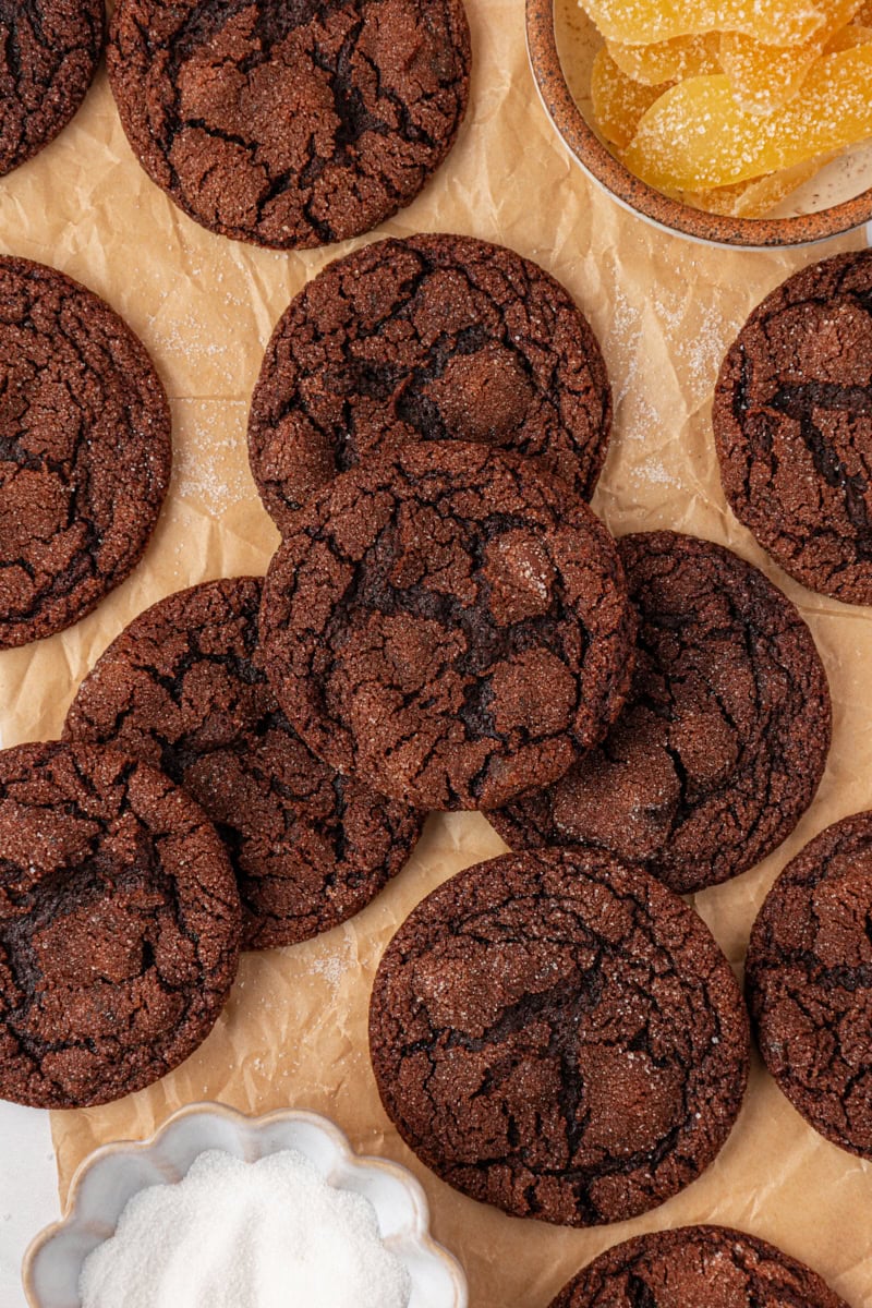 overhead view of chocolate ginger cookies scattered on parchment paper