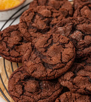 chocolate ginger cookies piled on a wire rack