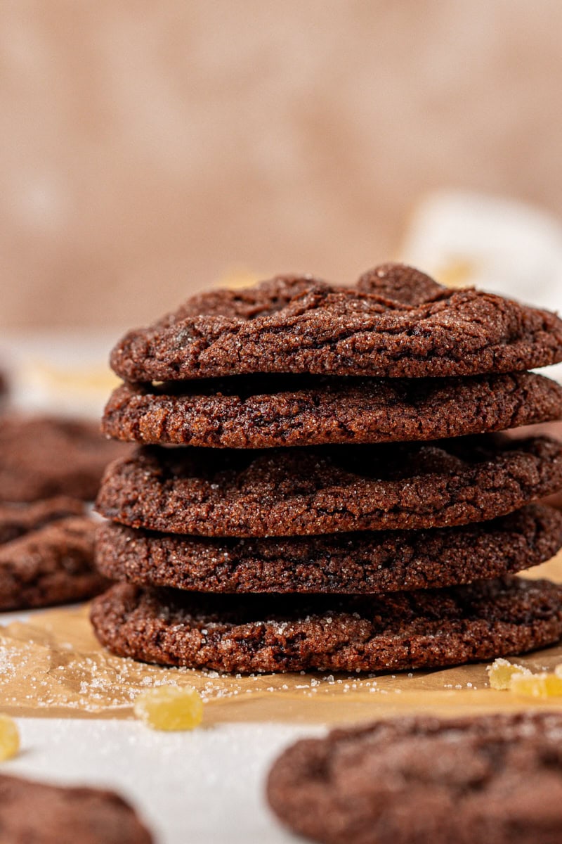 a stack of six chocolate ginger cookies on parchment paper
