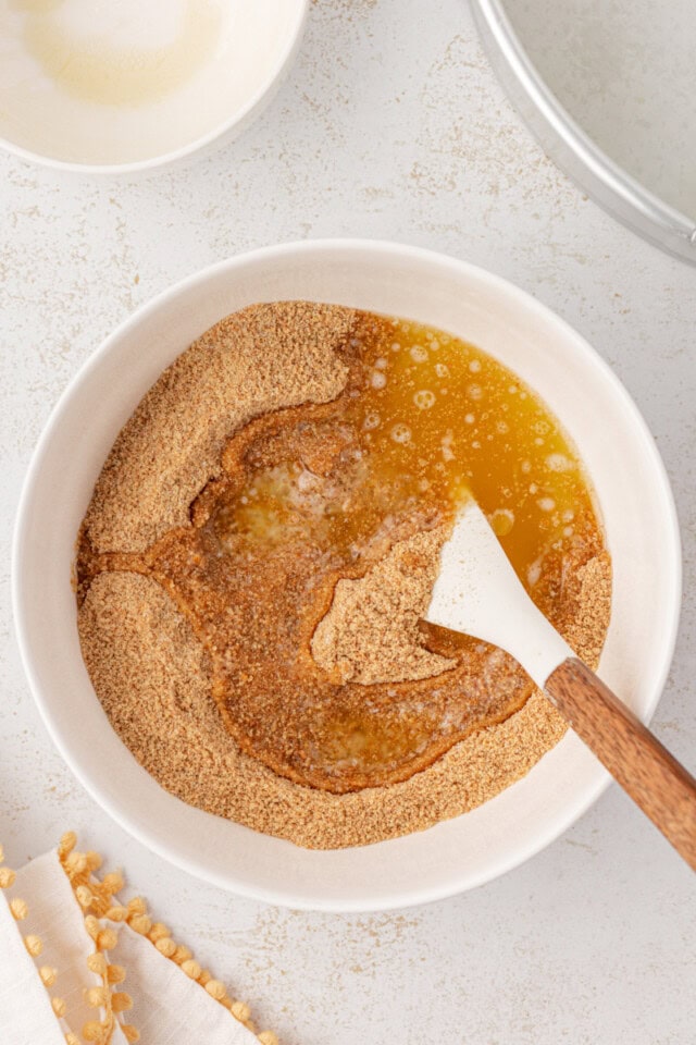 overhead view of melted butter added to graham cracker crust mixture