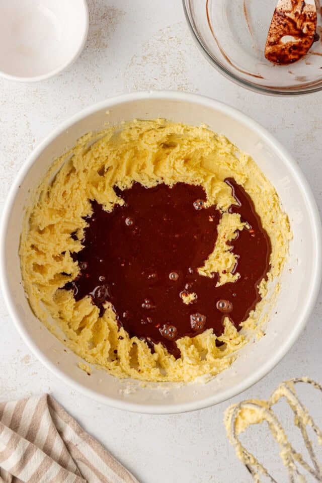 overhead view of melted chocolate and vanilla added to cake batter