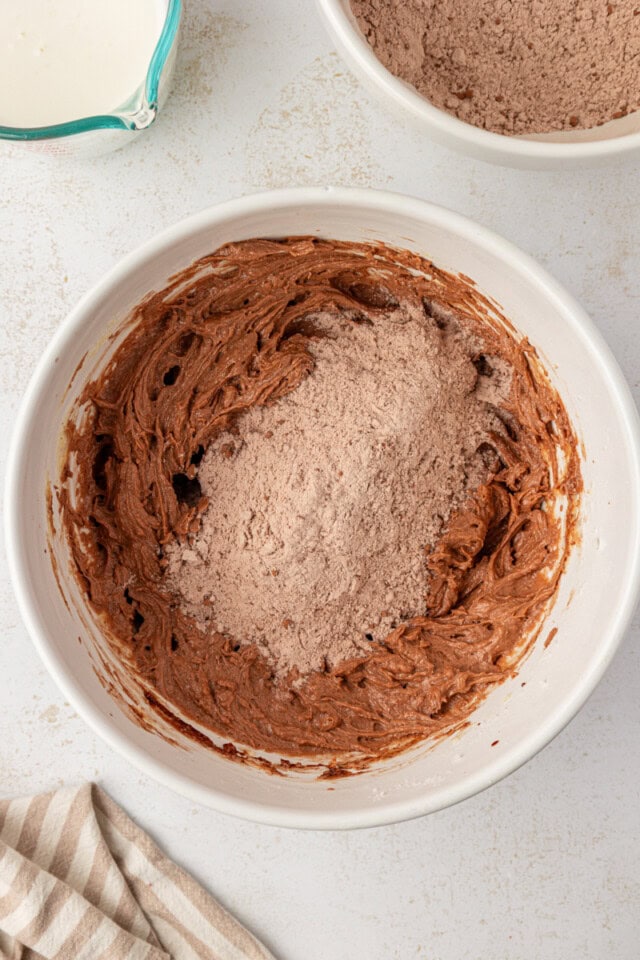 overhead view of buttermilk added to chocolate cake batter
