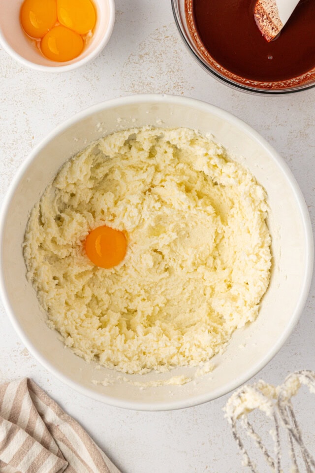 overhead view of egg yolk added to creamed butter and sugar